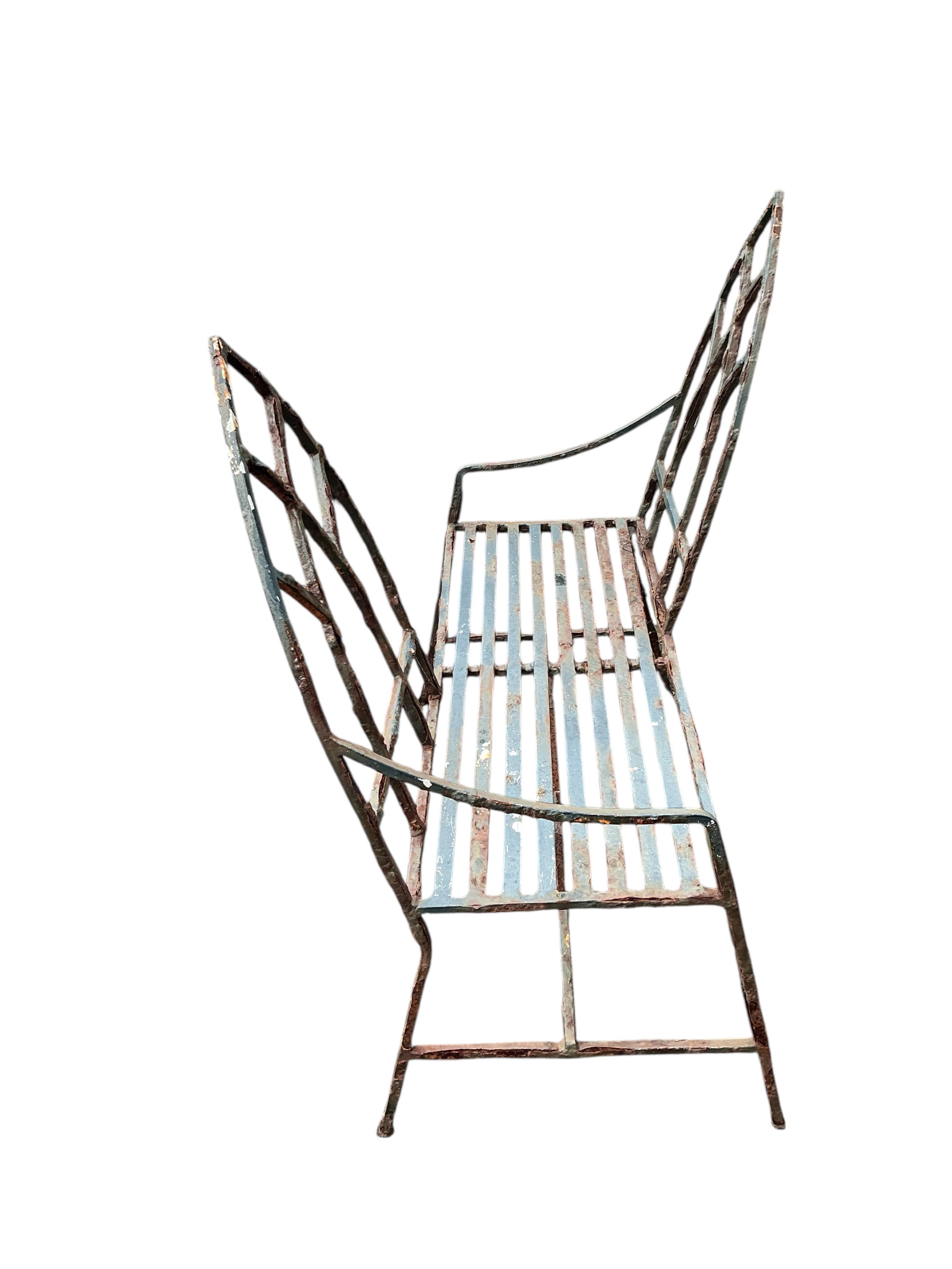 A Gothic style painted wrought iron garden love seat, width 94cm, height 98cm